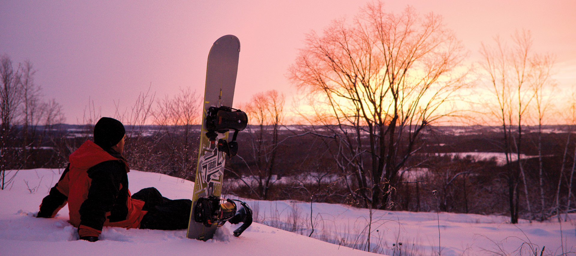 Person with snow board sunset